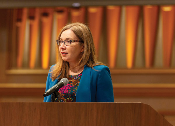 Dr. Katharine Hayhoe speaking behind a podium in Wynne Chapel.